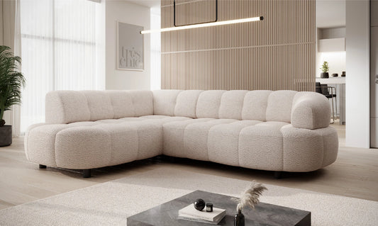 Beige sectional corner sofa VELPA L with electric seat adjustment, styled in a modern living room with a coffee table and decorative accents.