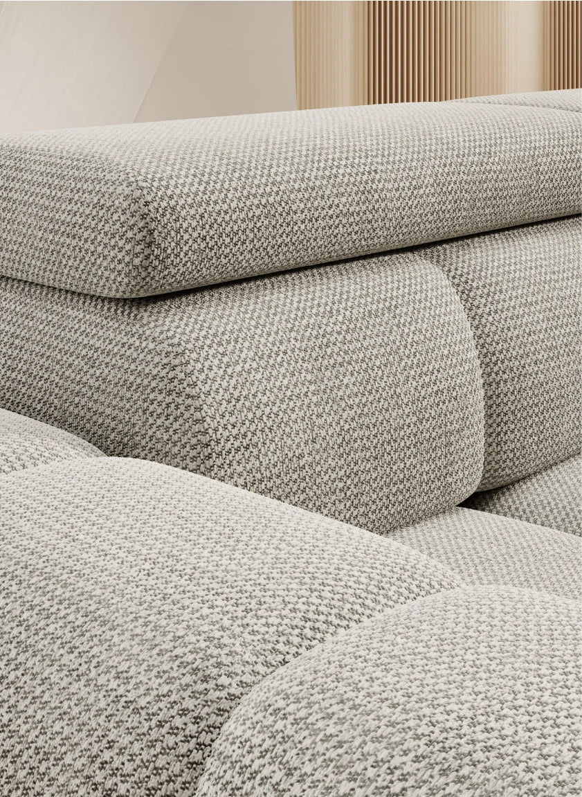 Close-up of BULL L corner sofa a textured gray sofa with a neutral background