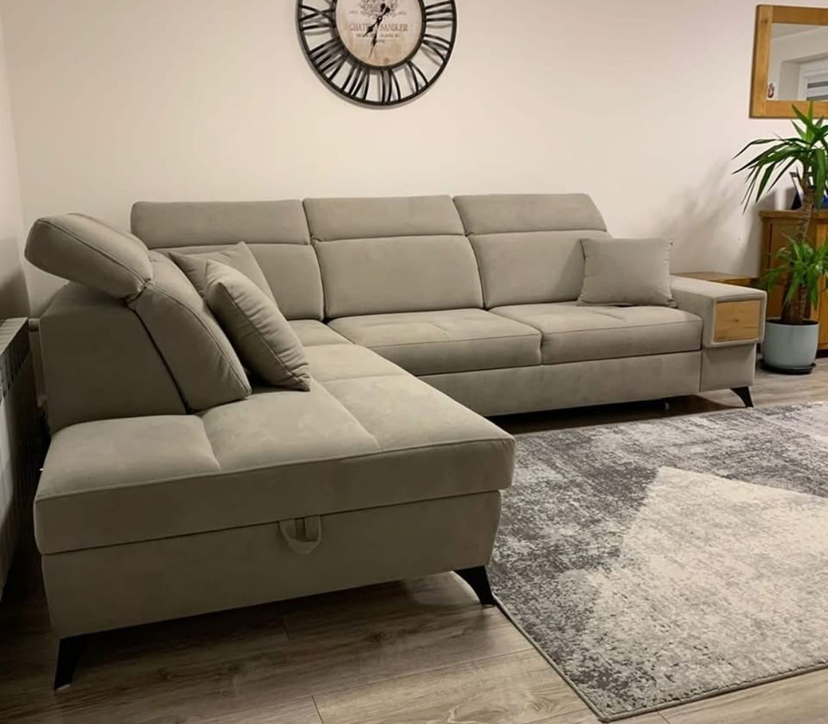 Gray corner sofa bed  Devine VII bed  in a living room setting with a clock on the wall.