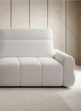 White sofa bed Mateo against a wooden paneled wall
