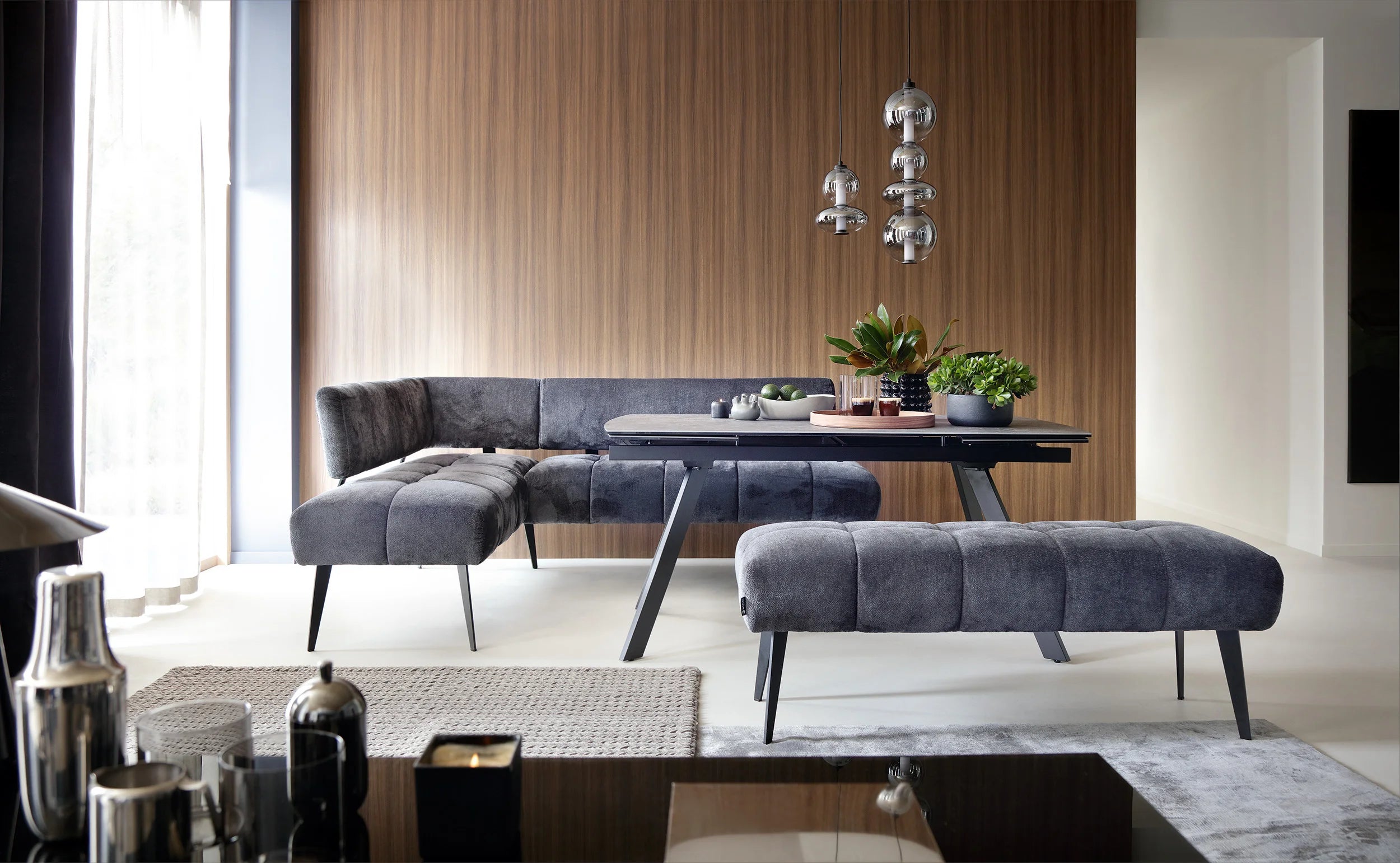 Modern living room with Milo dining corners sofa, dining table, and decorative elements.