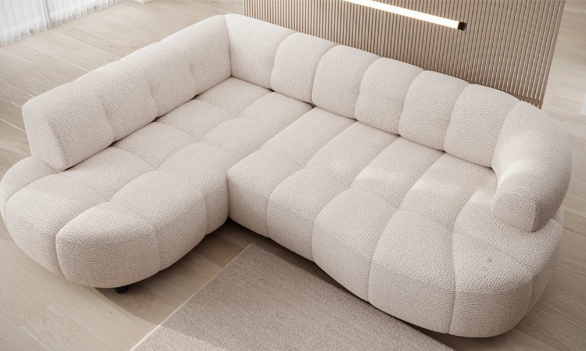 White sectional corner sofa VELPA L with electric seat adjustment, on a wooden floor with a neutral wall in the background