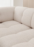 Close-up of a textured grey corner sofa VELPA L with electric seat adjustment in a neutral setting 