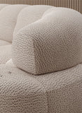 Textured beige corner sofa VELPA L with electric seat adjustment, with a close-up of a cushion