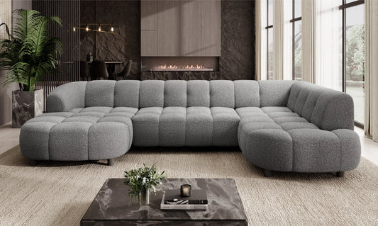Gray VELPA XL Large U-Shape sofa in a modern living room with a coffee table and decorative items. 
