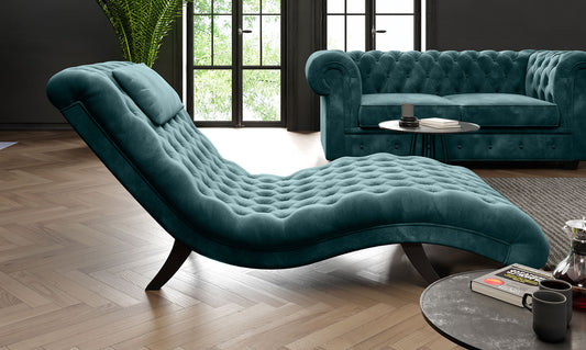 Teal chaise Lord lounge and sofa in a living room setting with a coffee table and decor items. 